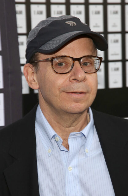 Rick Moranis posing on a red carpet