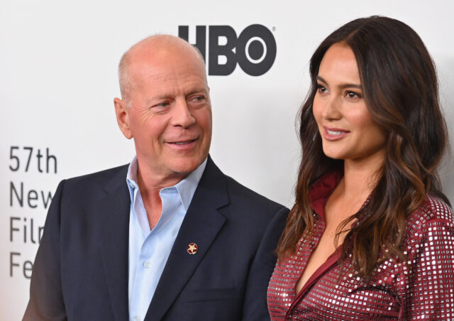 Bruce Willis looks at his wife Emma at a premiere