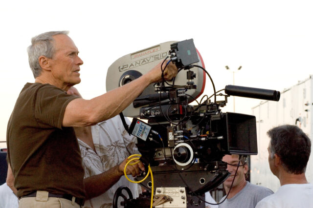 Clint Eastwood standing behind a movie camera