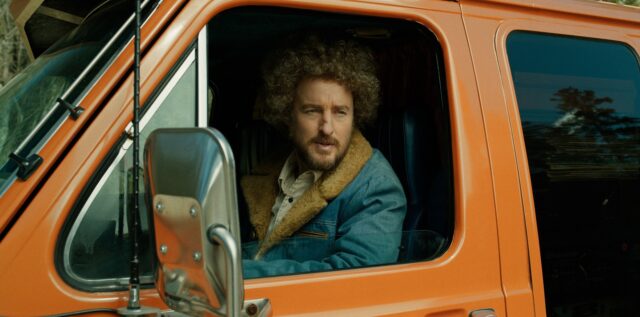 Owen Wilson as Carl Nargle from 'Paint,' seen through the window of a car.