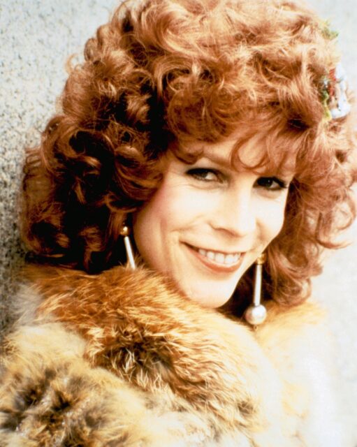 Jamie Lee Curtis wearing a fur coat as Ophelia in Trading Places. 