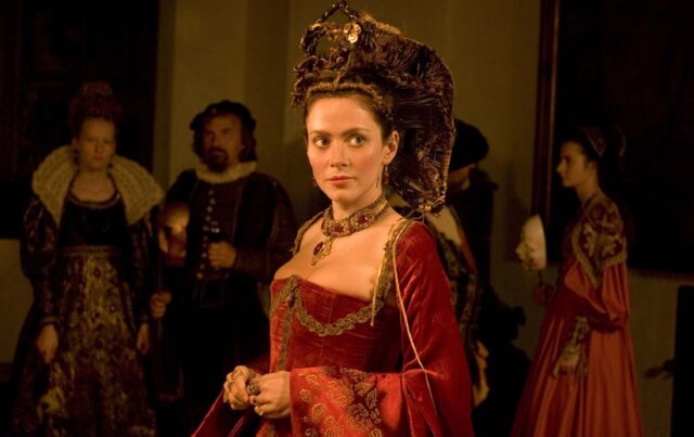 Anna Friel dressed as Elizabeth Báthory in 'Bathory.' People standing behind her.