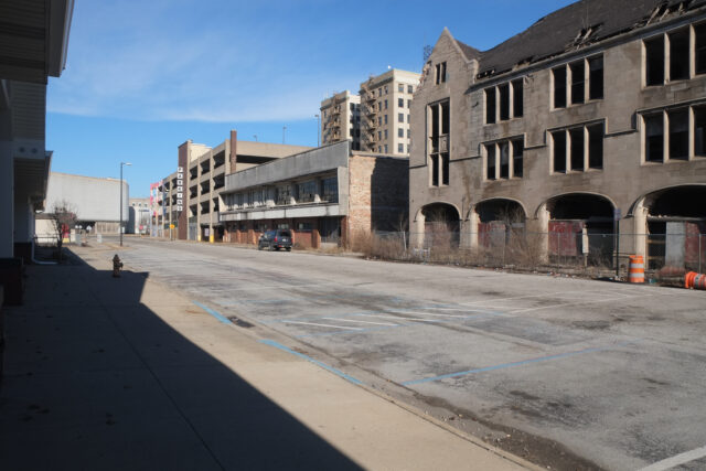 A street in Gary, Indiana, showing abandoned buildings and a parking garage.