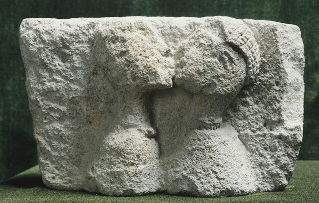 Two kissing heads etched in stone