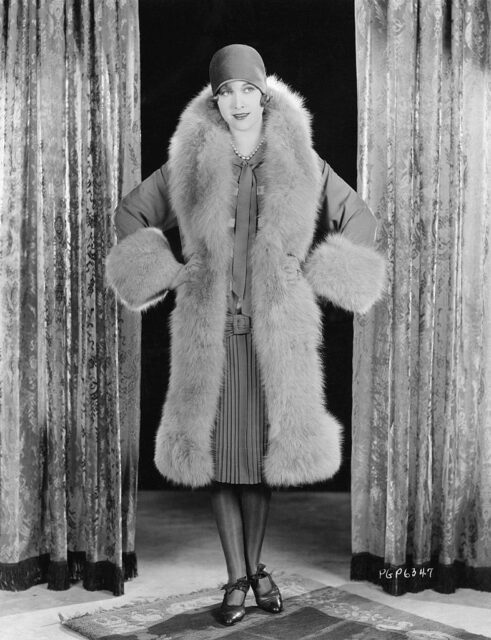 Esther Ralston posing in a fur coat
