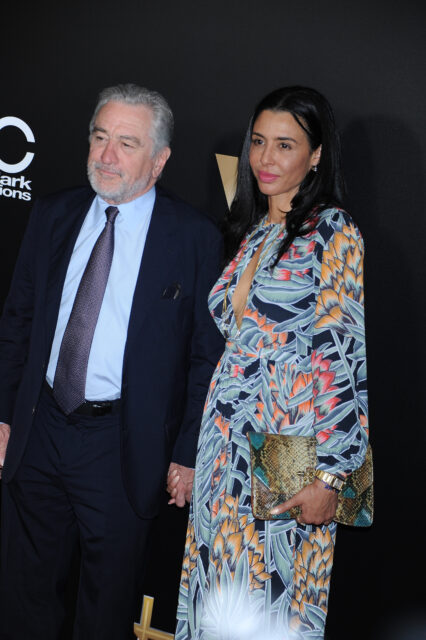 Robert and Drena De Niro standing on a red carpet