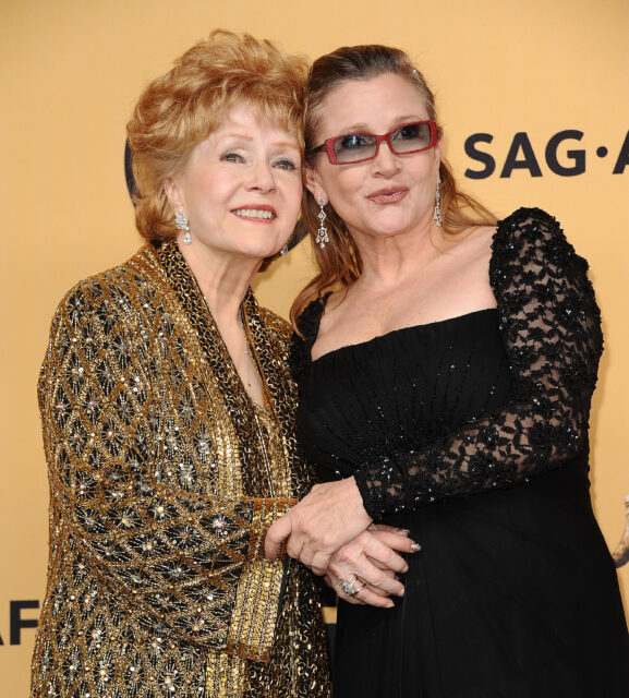 Debbie Reynolds and Carrie Fisher posing together on a red carpet