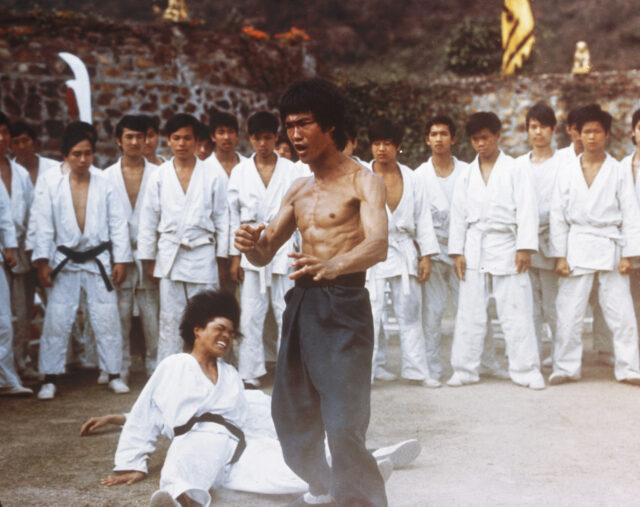 Bruce Lee surrounded by karate students