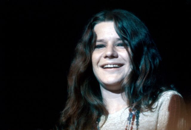 Headshot of Janis Joplin smiling.