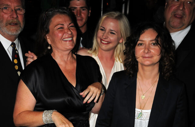 Roseanne Barr and Sara Gilbert surrounded by people