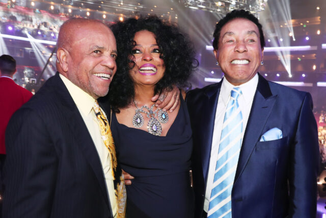 Headshot of Berry Gordy, Diana Ross, and Smokey Robinson posing together for a photo.