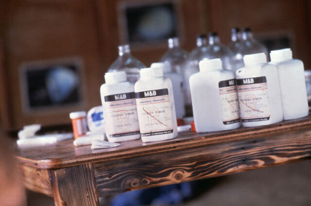 Vials of potassium cyanide on a wooden table