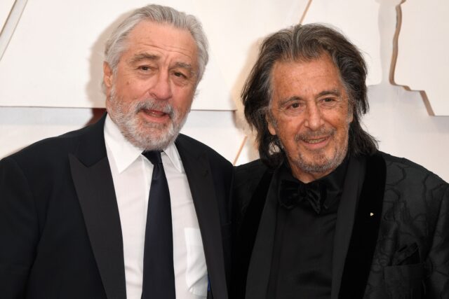 Robert De Niro and Al Pacino standing on a red carpet