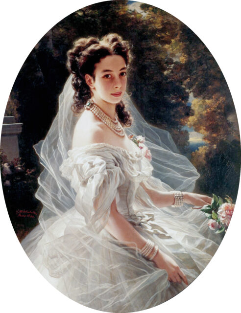 A portrait of Princess Pauline von Metternich, sitting sideways but looking at the viewer.