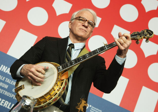 Steve Martin playing the banjo at an event