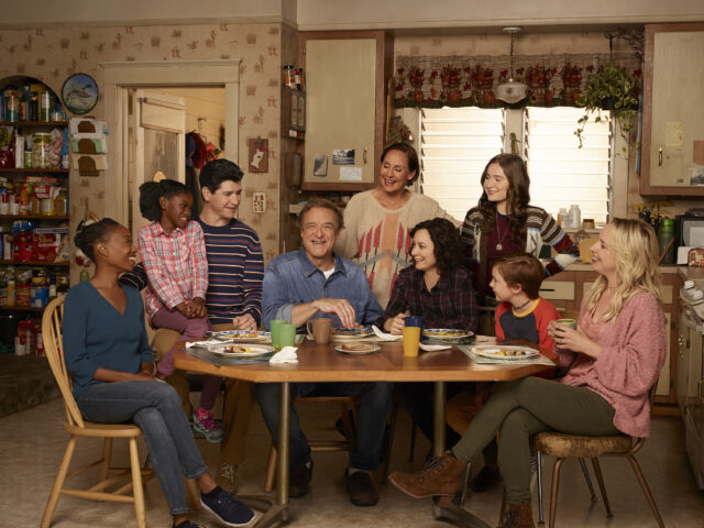 The cast of "The Connors" sitting at a table in a kitchen