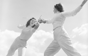 Two women fencing.