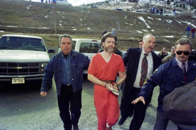 Ted Kaczynski walking with federal marshals