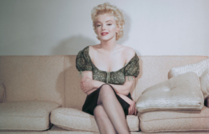 Portrait of Marilyn Monroe sitting on a couch