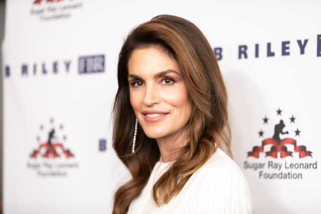 Cindy Crawford standing on a red carpet