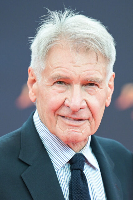Harrison Ford standing on a red carpet