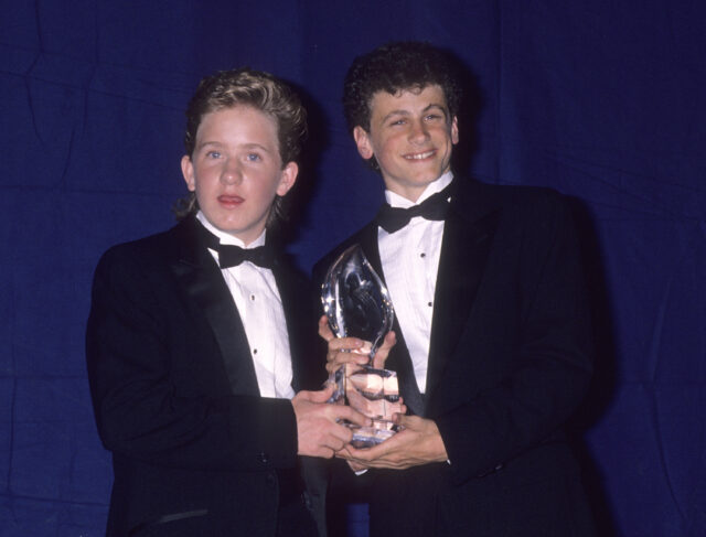 Jared Rushton and David Moscow holding an award together