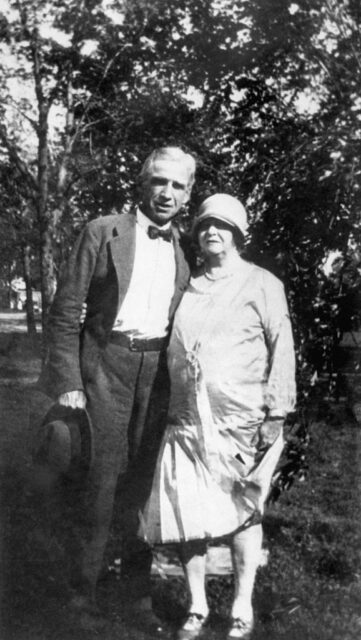Ma Barker and Arthur Dunlop posing together in a dress and suit.