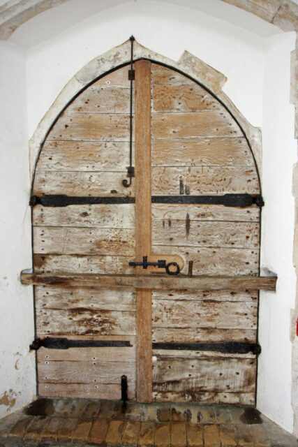 An arched wooden door to a church