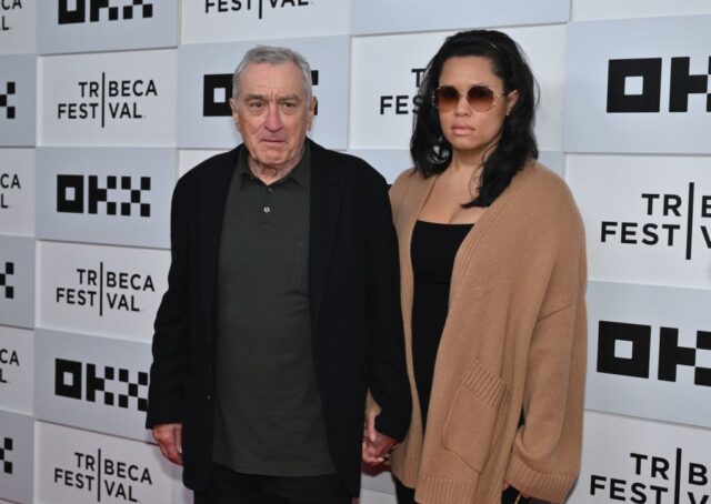 Robert De Niro and Tiffany Chen standing on a red carpet