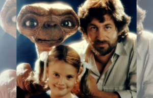 Steven Spielberg, Drew Barrymore, and E.T. posing for a photo together.