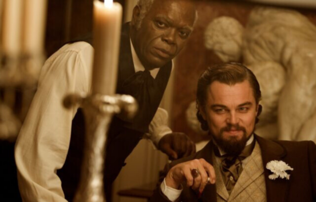 Leonardo DiCaprio sitting, Samuel L. Jackson leaning over him.