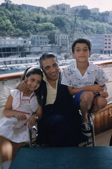 Christina, Aristotle and Alexander Onassis sitting together on a yacht