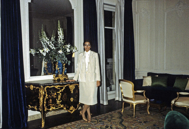 Christina Onassis standing near a mirror in her apartment