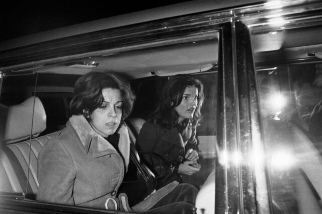 Christina Onassis and Jackie Kennedy sitting in the back of a car
