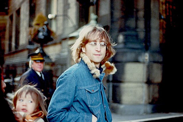 John Lennon wearing a denim jacket on the streets of New York in 1977