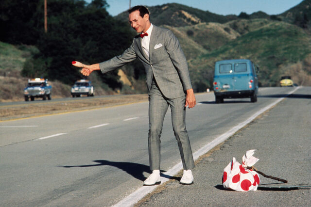 Pee-wee Herman hitchhikes in a scene