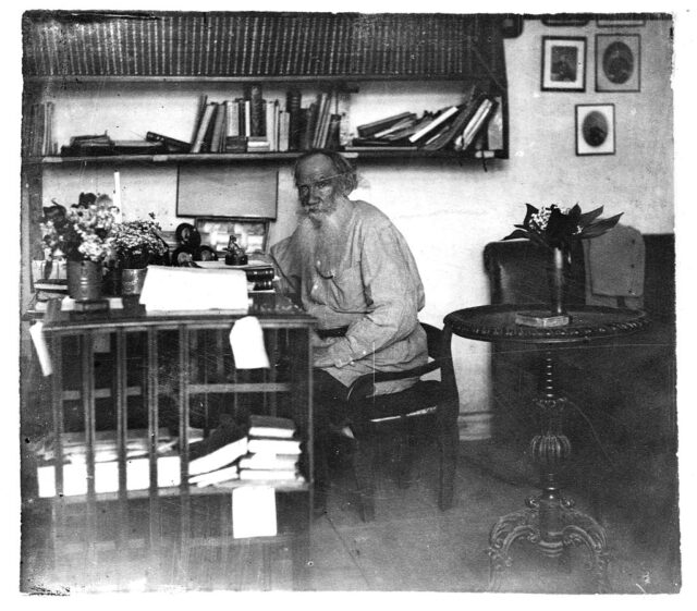 The writer Leo Tolstoy is seen writing at home