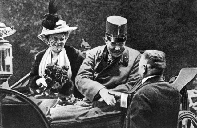 Franz and Sophie Ferdinand speaking to a man from the back of a vehicle