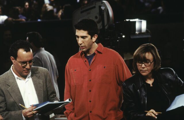 David Schwimmer standing with two of the writers on 'Friends'
