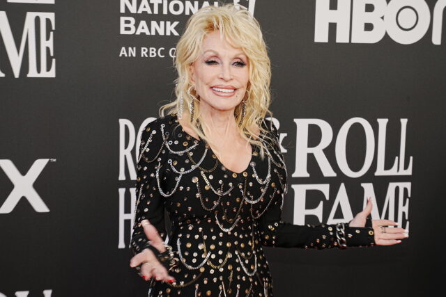 Dolly Parton standing on a red carpet