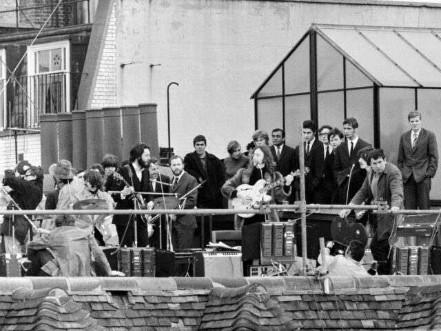Crowd watching The Beatles perform on a rooftop