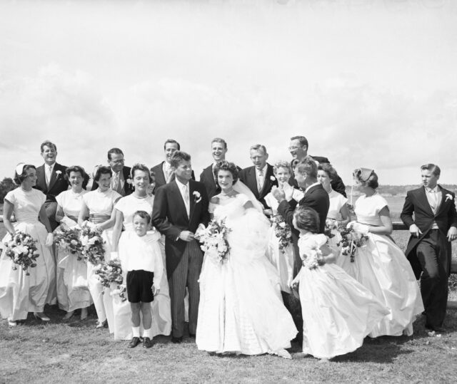 John F. and Jackie Kennedy standing with their wedding party