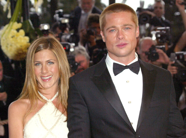 Jennifer Aniston and Brad Pitt standing together on a red carpet