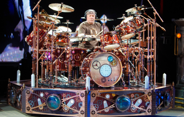 Neil Pearl playing the drums on stage