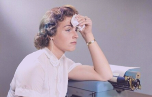 A woman pressing a tissue to her forehead