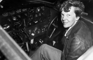 Amelia Earhart sitting in the cockpit of an aircraft