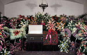 Flowers surrounding an open coffin