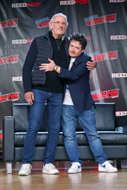 Christopher Lloyd and Michael J. Fox hugging each other on stage