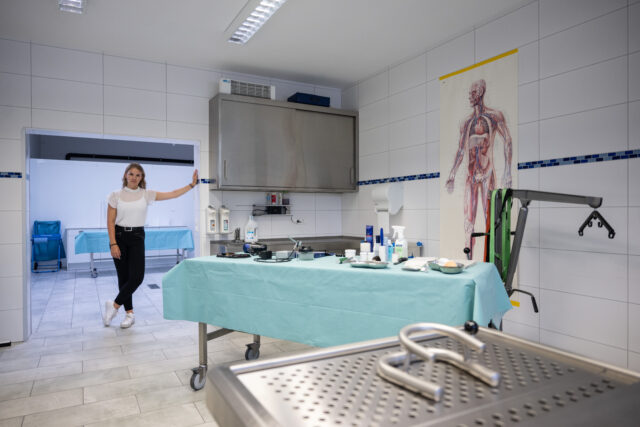 Woman standing in the entryway of a room in a mortuary