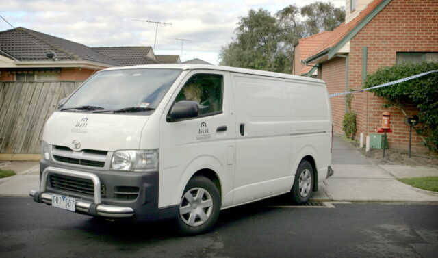 Mortician driving their van away from their facility